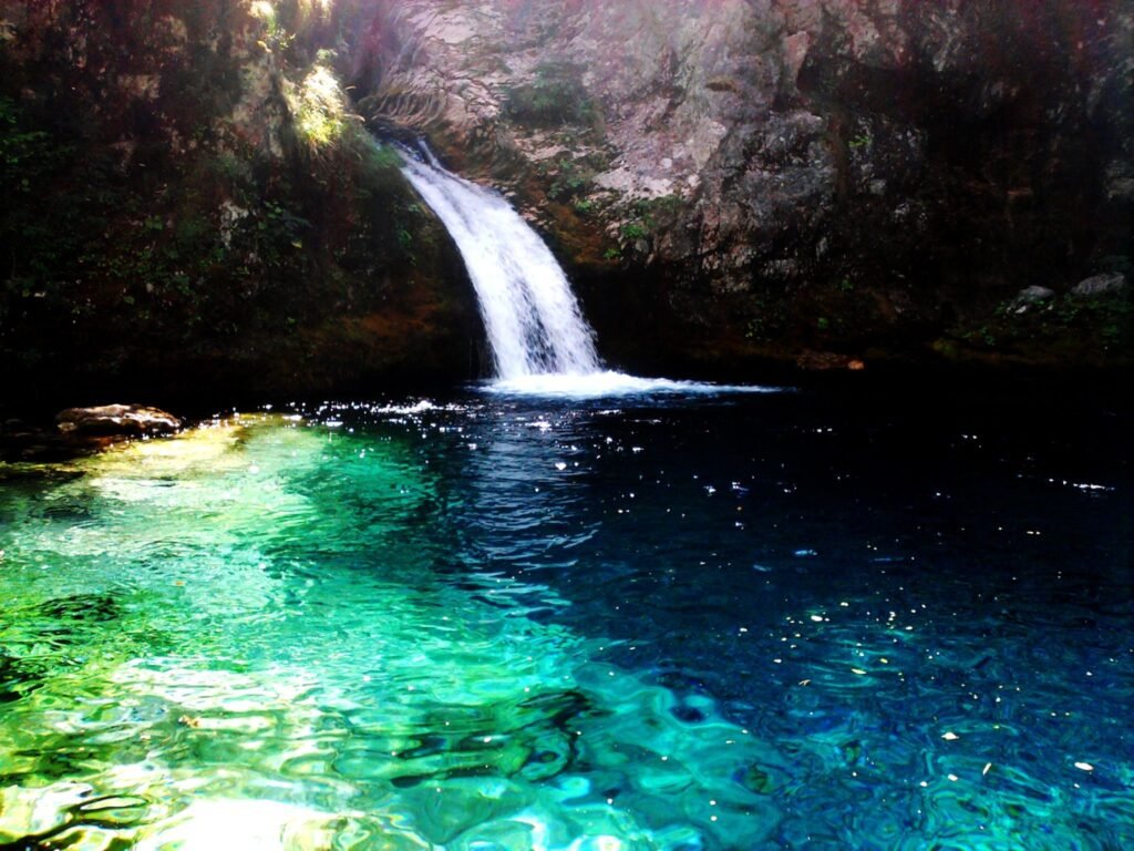 Crystal clear waters and waterfall of Syri i Kaltër in Theth, Albanian Alps