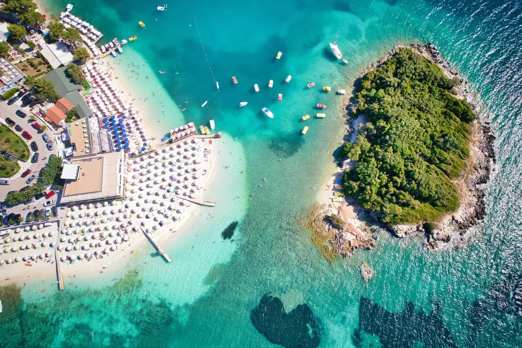 Aerial shot of Ksamil Island with azure waters and tranquil beachscape.