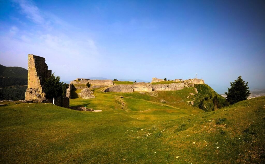 Exterior view of Kanina Castle, a historic fortress perched atop a hill, showcasing its ancient grandeur.