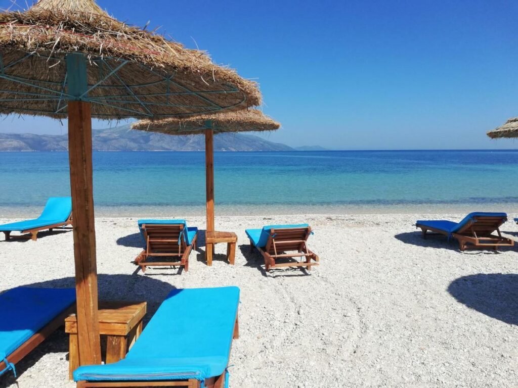 Scenic view of Orikum Beach with sun loungers, offering a peaceful escape along the Albanian Riviera.